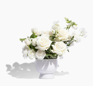 A white vase of white flowers in Denver