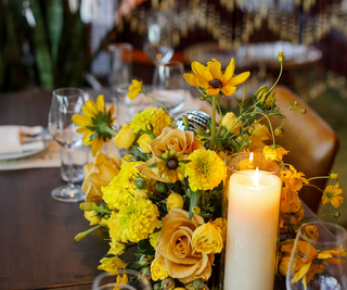 yellow flower disc ball centerpiece at a private event at Carne in Denver